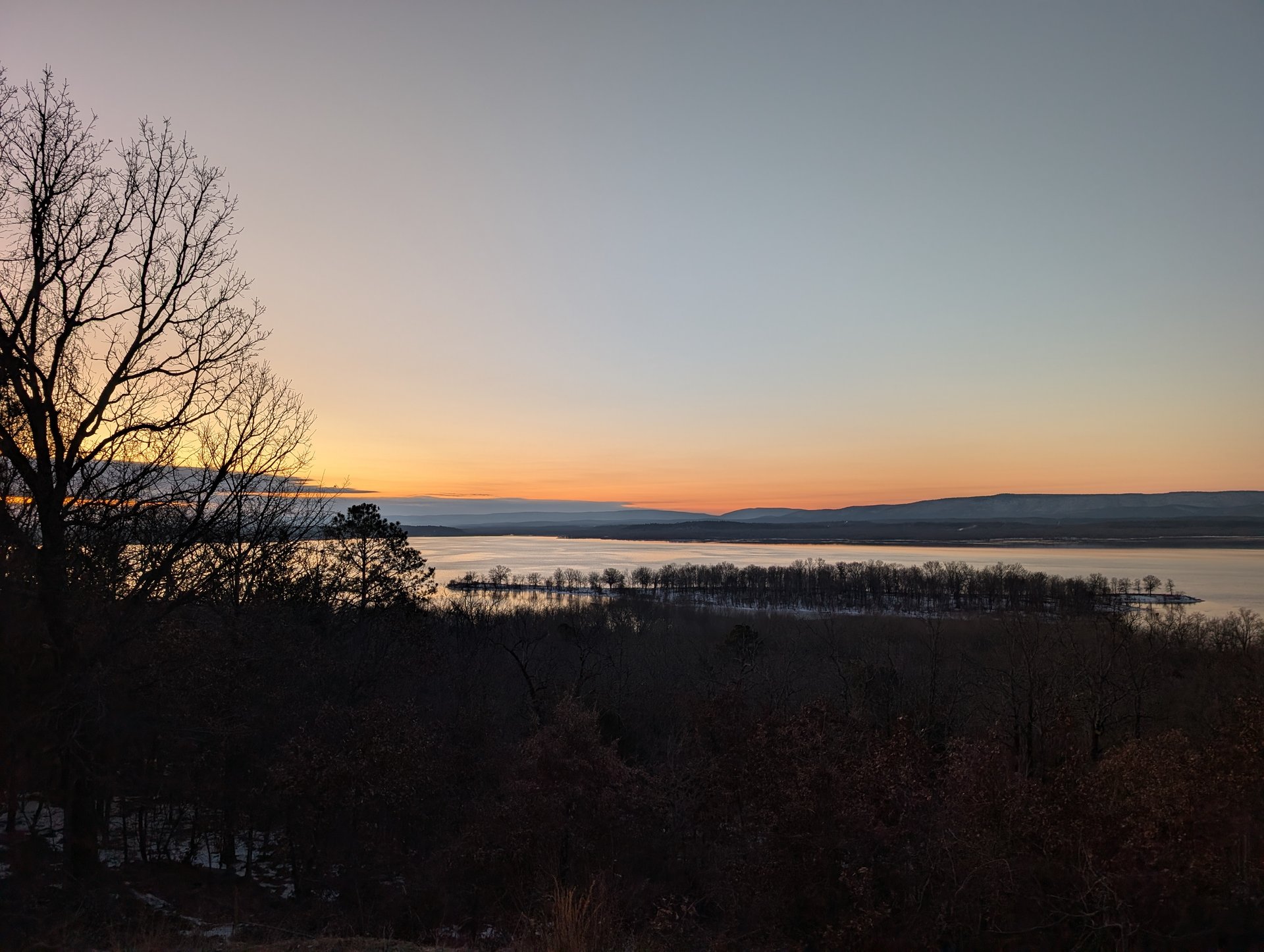 The sunrise that made losing sleep worth it — orange and gold streaking over Lake Wister