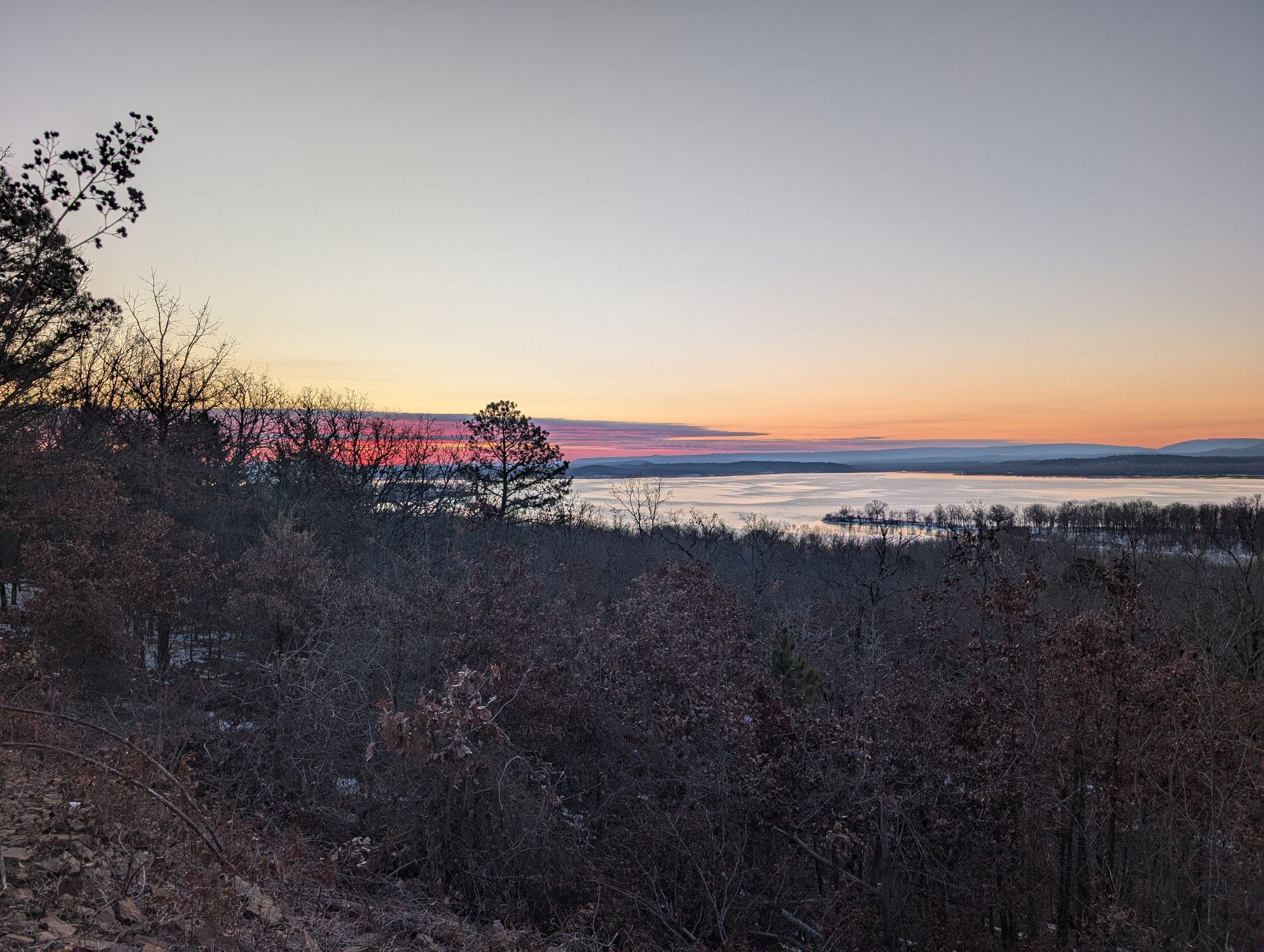Pink and orange light spilling over the hills on our last morning at the lake