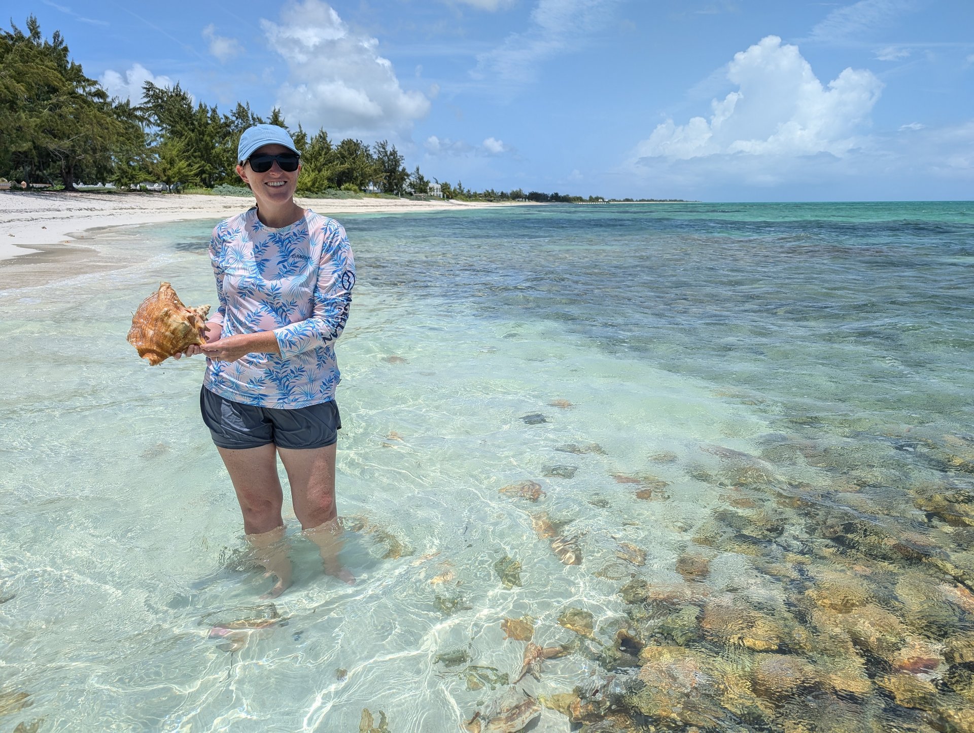 Kelly holding a conch shell