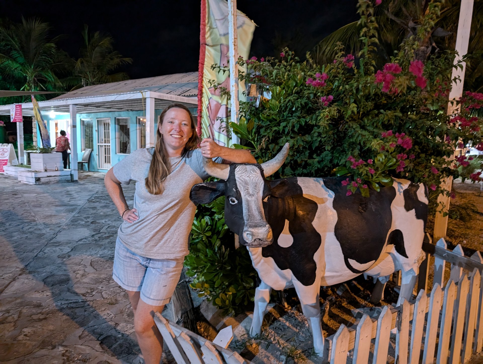 Kelly with the cow statue outside Caicos Bistro